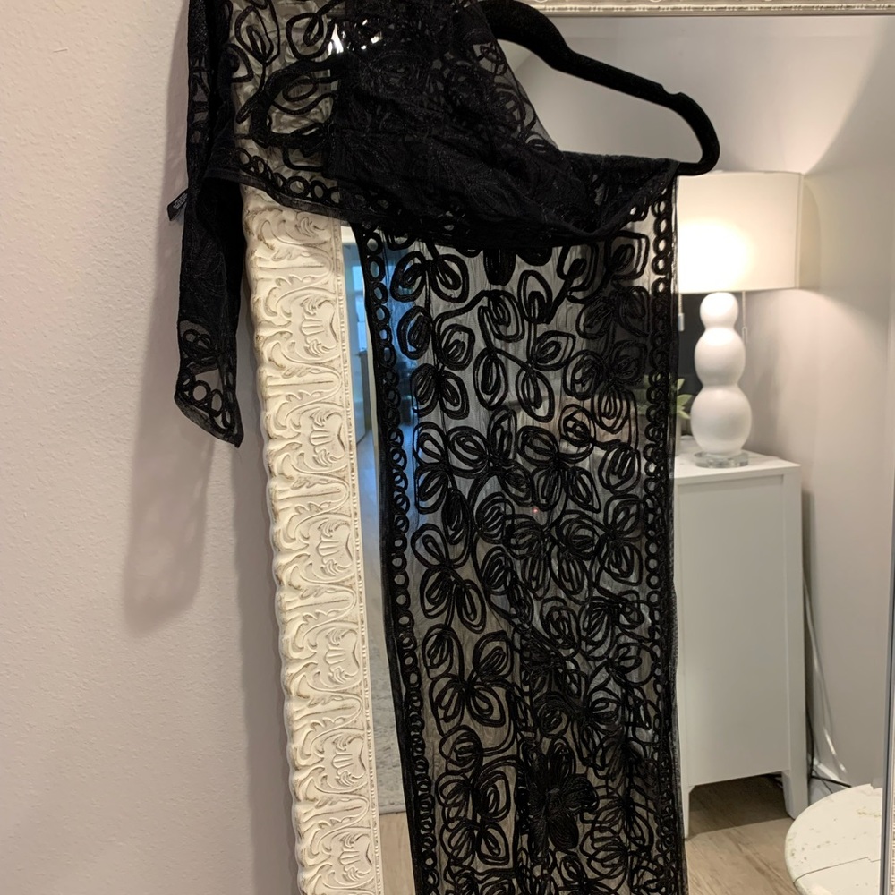 Black embroidered flowers on black wrap. Pretty accent piece.